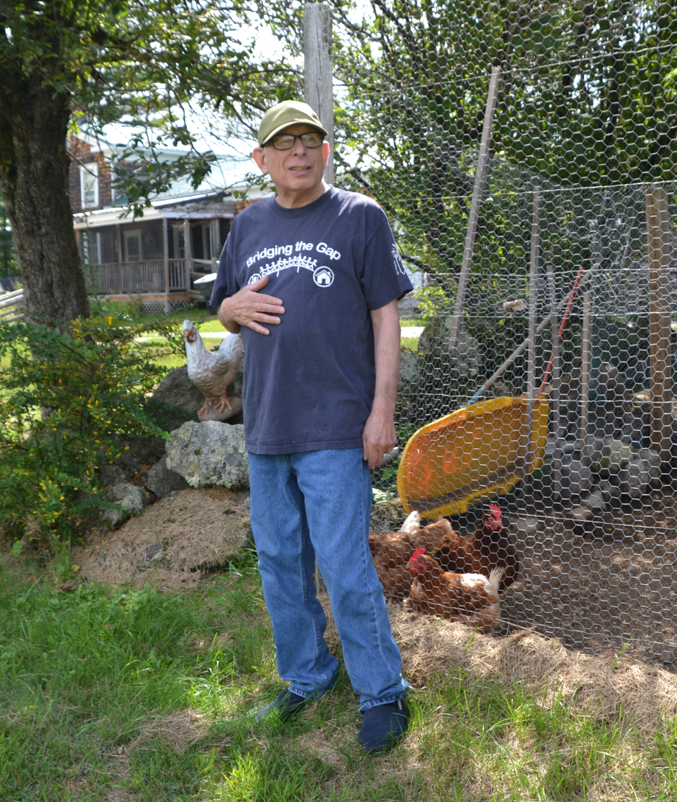 Jim Reed stands in front of his chicken coop